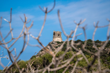 An old guard tower on a hill at the beach of Villasimius, Sardinia.