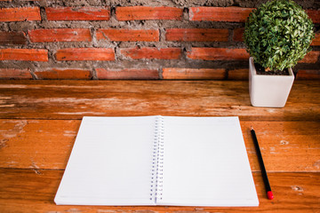 Blank notebook white screen on wooden table