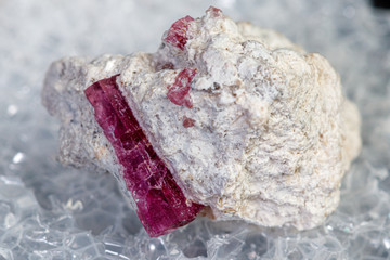 macro mineral stone red beryl on a black background