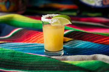 Margarita cocktail with tequila, orange liqueur, lime juice, with a salted rim, and garnished with...