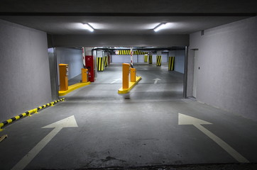 Underground parking under shopping center in the evening. Underground garage with one parked car....