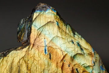 macro mineral stone labradorite on a black background