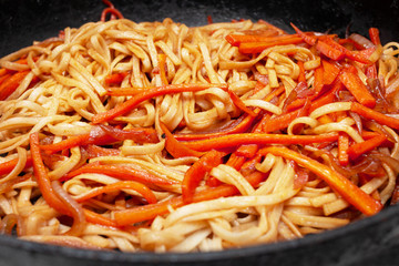 Udon noodles with carrots. Japanese cooking