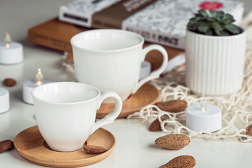 Fototapeta na wymiar Composition with white coffee tea white cups
