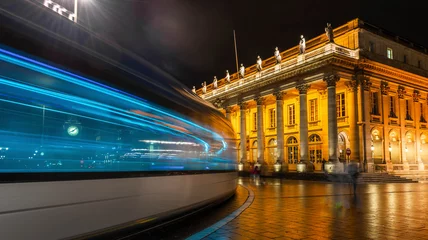 Fotobehang Tram passing the Grand Théâtre de Bordeaux at night in Gironde in New Aquitaine, France © FredP