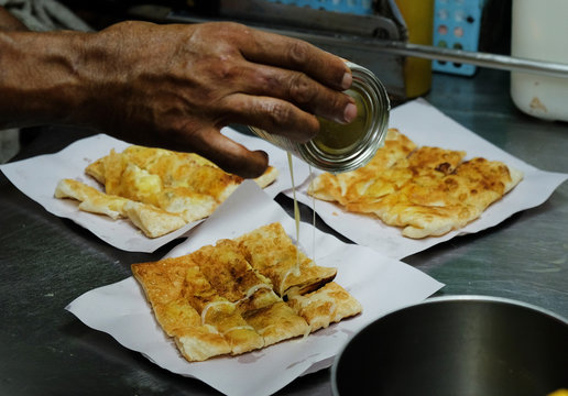 Cooking banana pancakes or roti with condensed milk