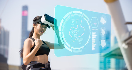 sports technology concept.Beauty asian woman running by virtual reality in the city. VR headset...