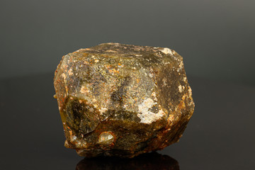 macro mineral stone Andradite on a black background