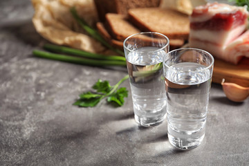 Cold Russian vodka with snacks on grey table