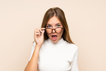 Young blonde woman over isolated background with glasses