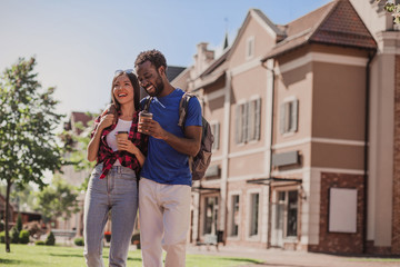 Fototapeta premium young man hugging woman in the city drinking coffee
