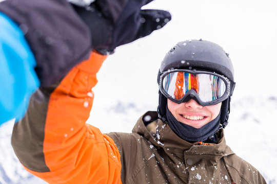 Ski resort Fellhorn, Oberstdorf, Bavaria, Germany: Male skiers high-fiveing after a good run down the mountain.