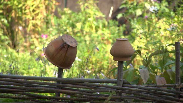 Old jugs hanging on a fence in an ethnographic museum as household items of ancient peoples