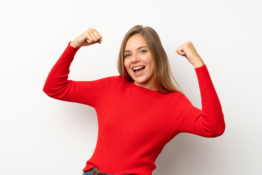 Young Blonde Woman With Red Sweater Over Isolated White Background Celebrating A Victory