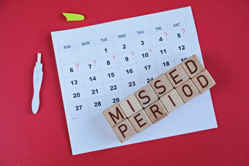 Missed period marked on calendar, pregnancy test. Woman's health and delay in menstruation.