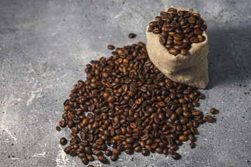 coffee beans in a bag on gray stone background