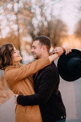 Romantic young couple hugging in the park on an autumn day, closeup portrait