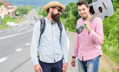 Looking for transport. Men edge road hitchhiking. Friends gathered to travel together. Travelers...