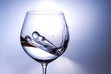  splash of water from a wine glass on a light background