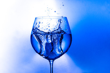 splash of water from a wine glass on a light background