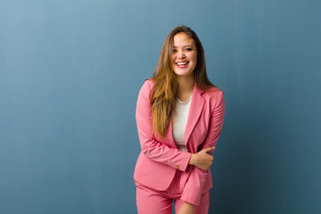 businesswoman laughing shyly and cheerfully, with a friendly and positive but insecure attitude