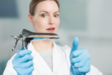 Female gynecologist with a speculum in her hand