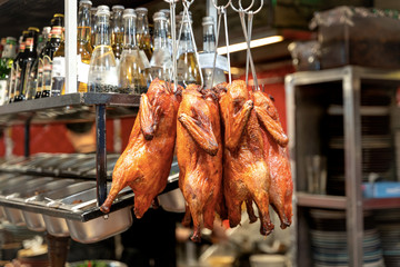 Whole grilled chicken hanging at restaurant