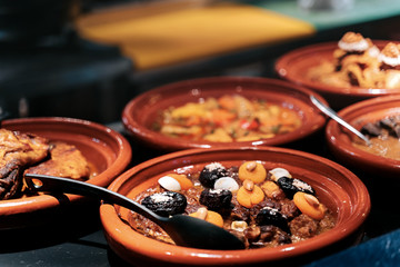 Meat tajine is a moroccan dish in sauce with dried fruits like prunes, apricot and toppings with...