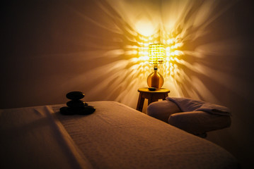 Professional massage relaxation lights and hot stones with coconut oil