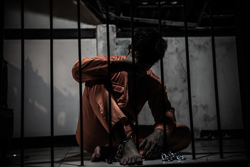 Asian man desperate at the iron prison,prisoner concept,thailand people,Hope to be free,Serious...