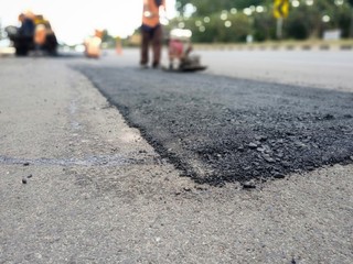 Road surface leveling work With asphalt paving (picture blurred)