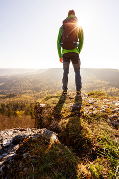 Albstatt-Onstmettingen, Baden-W&cedil;rttemberg, Germany: A male hiker on the "Hangender Stein" cliff along the "Traufgang Zollernburg-Panorama" trail.