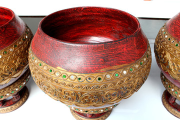 The monk's alms bowl made of red wood and decorated with beautiful Thai pattern