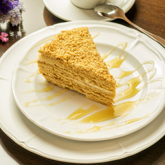 Traditional festive honey cake on the white plate closeup.