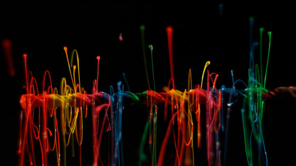Colorful paint swirling and bouncing into the air