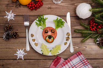 Edible Christmas deer made of vegetables for the festive New Year and Christmas table. Idea for decorating holiday dishes. How nice to serve vegetables.