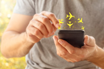 Man using hologram app on his phone for finding plane ticket