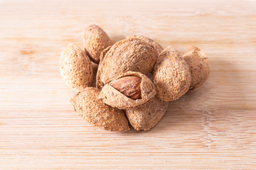 almonds isolated on wooden background