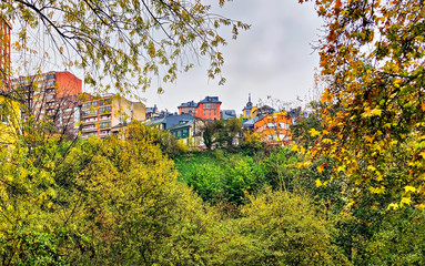 Fototapeta na wymiar Autumn season foliage adds color to a cityscape of Ponferrada in northern Spain.