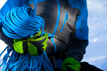A man flakes a rope after climbing Curtains (WI4) in Hyalite Canyon in Montana.