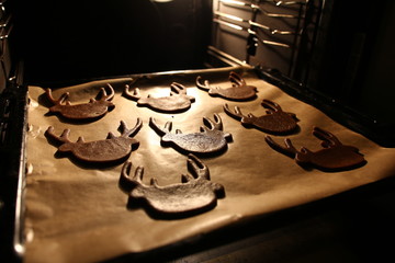 Christmas - baking gingerbread - baking tray with gingerbreads in the oven
