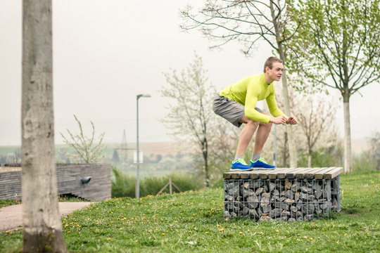 Basketball athelete  jumping on and off a bench as part of his workout.