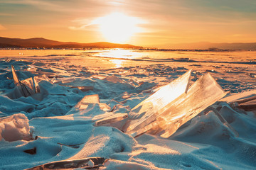 Clear blue ice with bubbles. Lake Baikal in winter. Ice texture with space to copy