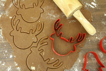 Christmas - baking gingerbread - rolled out dough with reindeer cutter form