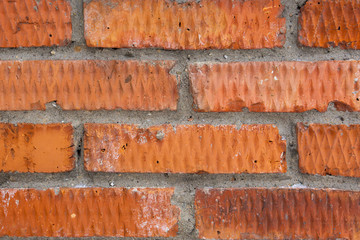 Abstract background in the form of an old brickwork of brown color and a metal stove rusty door...