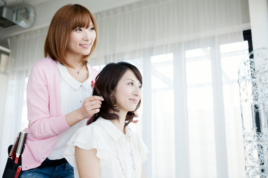 髪をセットする美容師