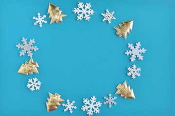 Turquoise Christmas background with white snowflakes and golden new year tree border and empty...