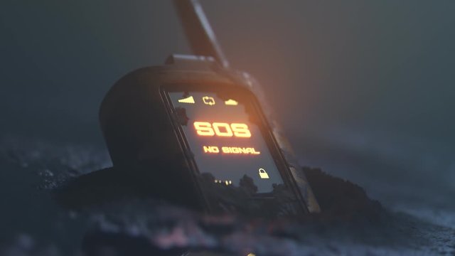 Close up of walkie-talkie left on the ground showing flashing SOS signal. 4K HD