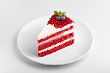 Red Cake isolated at white background. Slice of red cake with blueberries and mint. Christmas pie isolated.