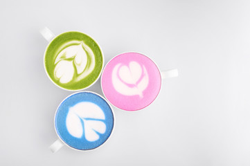 Three matcha tea cups at white background. Green, pink and blue matcha. Detox drink concept. Natural beverages
